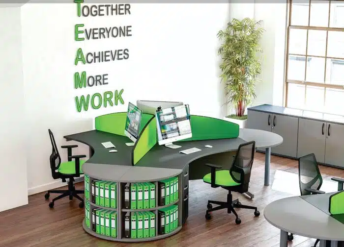Sirius Desks And Workstations 3 person configuration in graphite with conference links, shelving, 3 drawer pedestals nad green desk screens