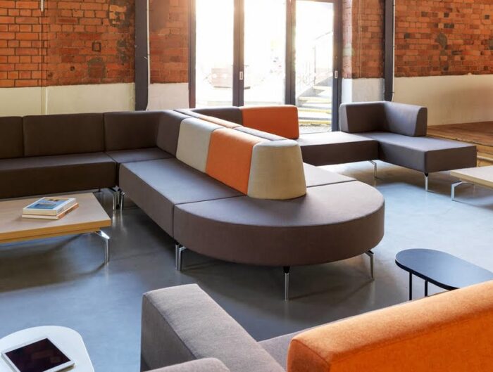 Skyline Seating shown with chrome feet and matching tables in a breakout or reception area
