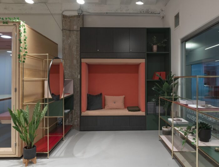 Snugglestor with padded seating, cushions, closed and open storage shown with palisades luxe shelving units in a breakout space