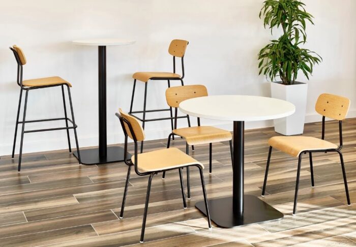 Solo Breakout Chair And Stool 3 chiars and 2 stools with black frames and oak plyform seats and backs with tables in a breakout space