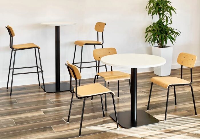Solo Breakout Chair And Stool 3 chiars and 2 stools with black frames and oak plyform seats and backs with tables in a breakout space