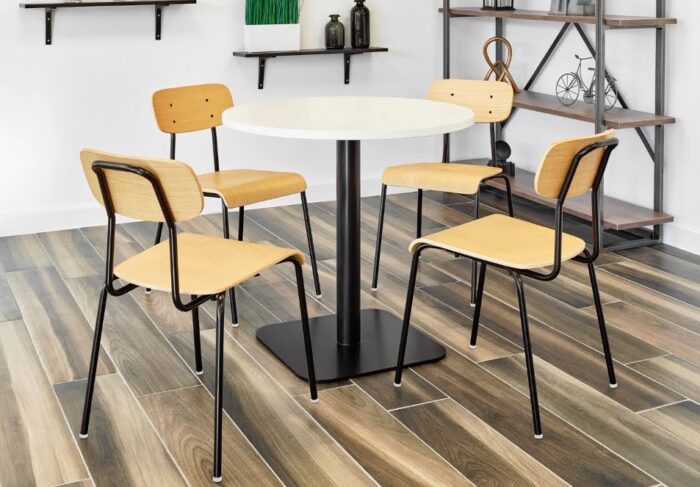 Solo Breakout Chair And Stool 4 chairs with black frames and oak plyform seats and backs around a dining height table