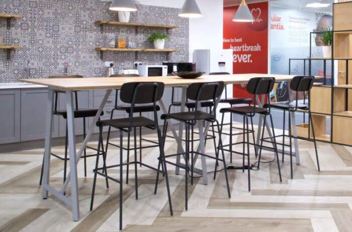 Solo Breakout Chair And Stool 8 stools with a poseur table shown in a dining area