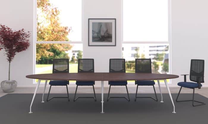 Spire Tables shown with oval top and white legs shown in a meeting room