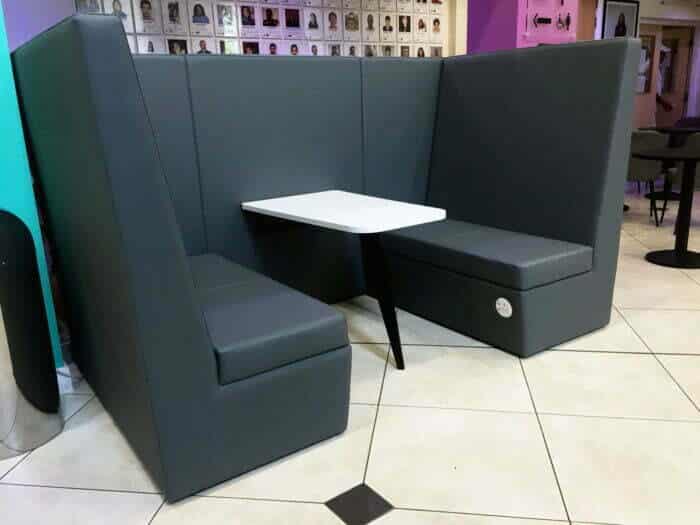 Stella Modular Seating high back 4 seat den with integrated power module and table in a breakout space