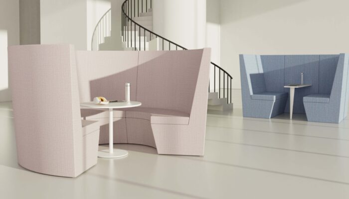 Stella Modular Seating high back curved booth in pastel pink shown with a Stella round table and high back square den in pastel blue