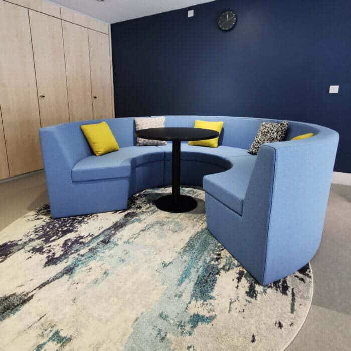 Stella Modular Seating low back curved unit shown with a Stella round table