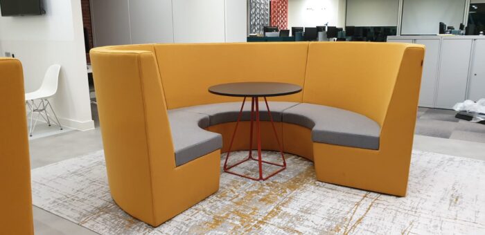 Stella Modular Seating mid back curved unit shown with a round table