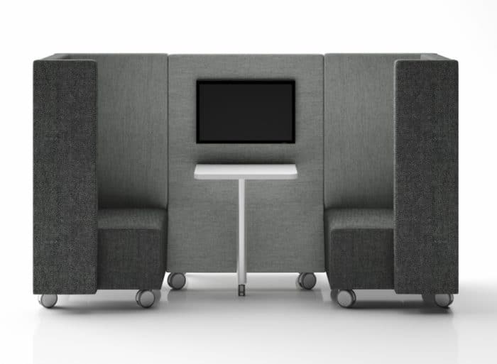 Stream Booths - high back 2 seater booth with half depth arms on optional castors in two tone upholstery, shown with integrated a table and screen mounted monitor