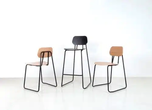 Swing Chair And Stool - a stool shown with black stained ash seat and backrest and two chairs with natural oak veneer seats and back rests