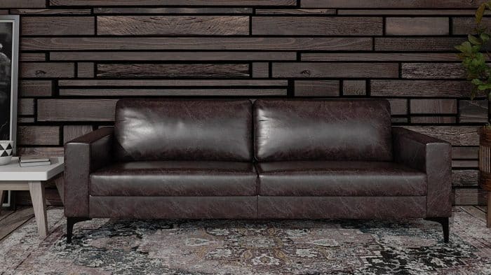 Target Seating - three seater sofa with leather upholstery and black legs in lounge area