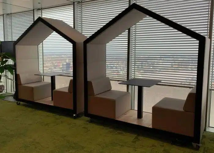 Treehouse Dual Booth two open booths with seating and table, shown by a workplace window