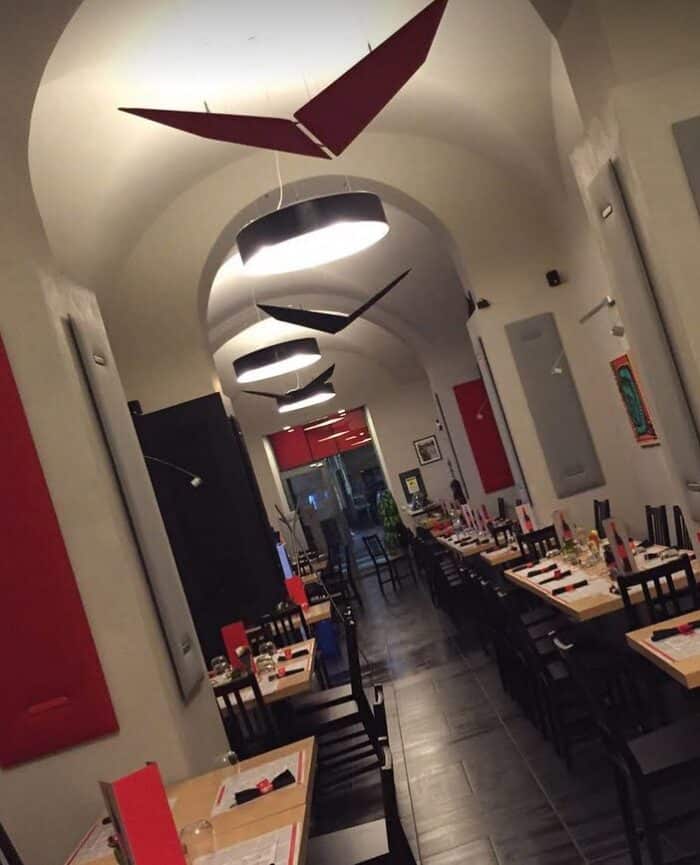 V-Volo Ceiling Panels three pairs of suspended panels in red and black sound absorbing fabric shown in a dining space