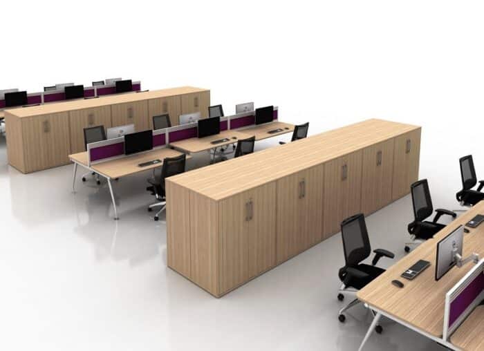 Vega Bench Desk three rows of 6 person back to back desks shown with low level storage used as dividers