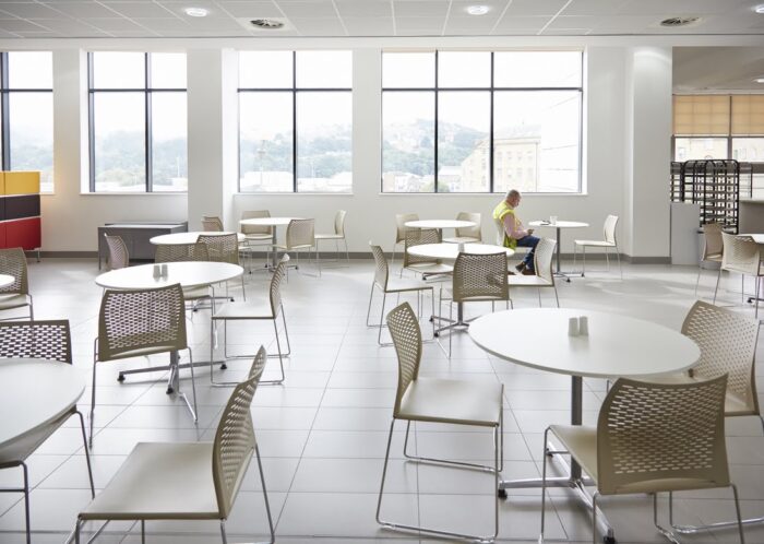 Xpresso Perforated Chairs group of chairs with no arms and circular table in a breakout dining space