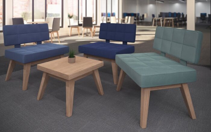 Xross Soft Seating three upholstered single chairs shown with a square side table in a breakout space