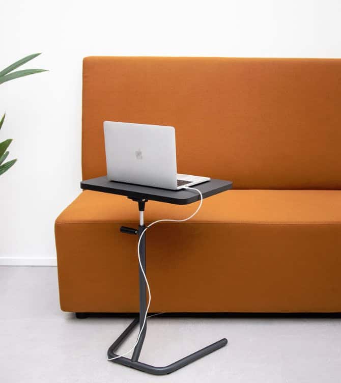 Y-Table shown in front of a sofa with a laptop on the surface