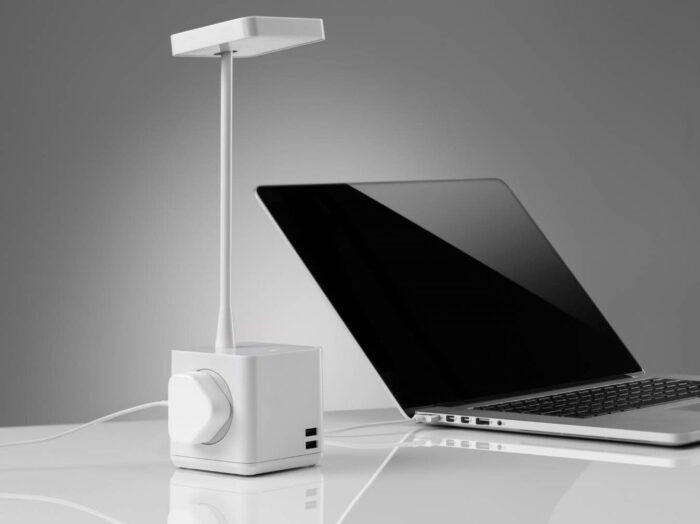 Cubert Desk Lamp providing power for a laptop