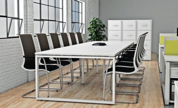iBench Desk 12 seat table with hoop leg frame shown in a meeting area