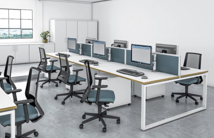 iBench Desk back to back configuration shown with hoop legs, desktop screens and pedestals in a work place