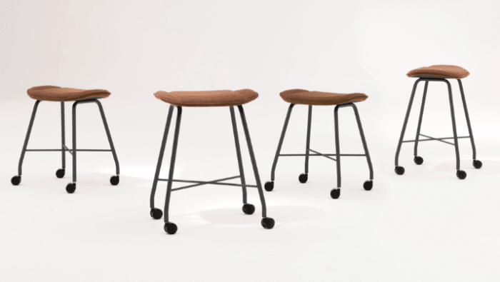 Roam Stool group of units shown with upholstered seats, black metal 4 leg frames and castors