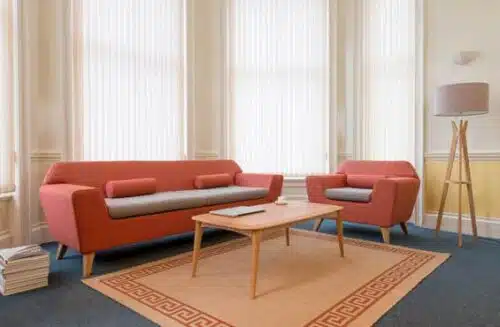 Stretch Soft Seating single seat and 3 seat sofa with a coffee table shown in a lounge space